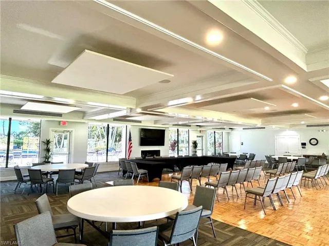 Spacious clubhouse featuring beamed ceiling, ornamental molding, and recessed lighting. A perfect gathering spot for the many social events
