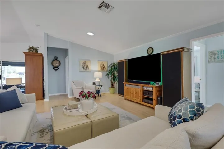 Living room featuring light wood-style flooring and lofted ceiling