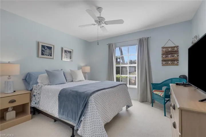 Bedroom featuring light colored carpet and a ceiling fan