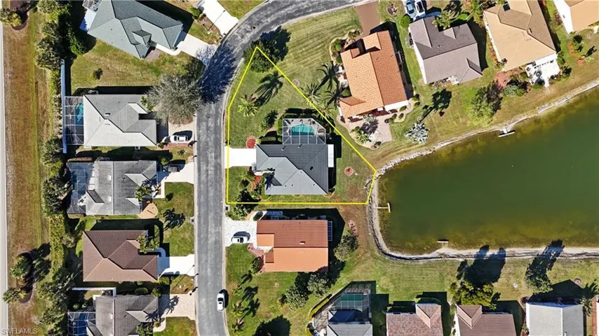Aerial perspective of suburban area featuring a large body of water