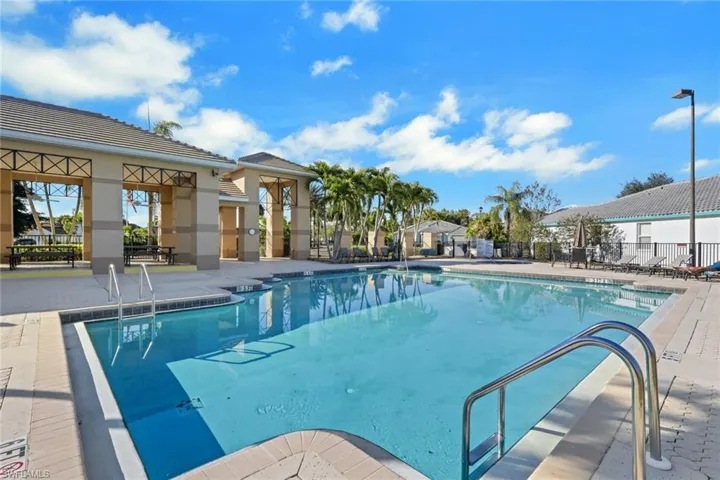 Community pool with a patio