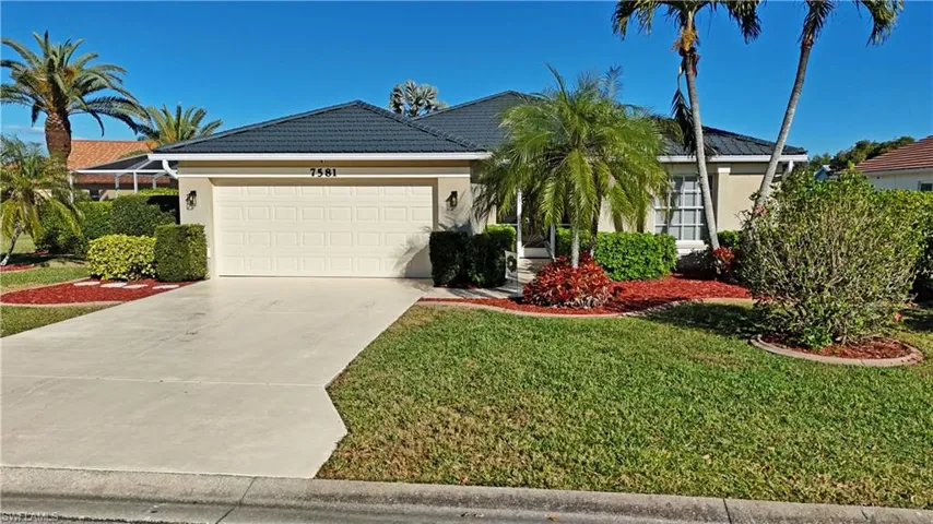 Ranch-style house with stucco siding, concrete driveway, a garage, and a tile roof