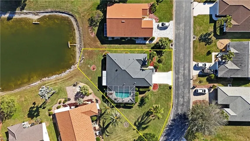 Aerial view of residential area featuring a nearby body of water