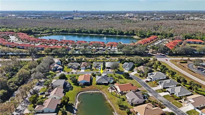 Aerial view of property's location featuring a nearby body of water and nearby suburban area