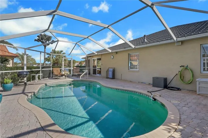 Swimming pool featuring a lanai, a patio, and a sunroom