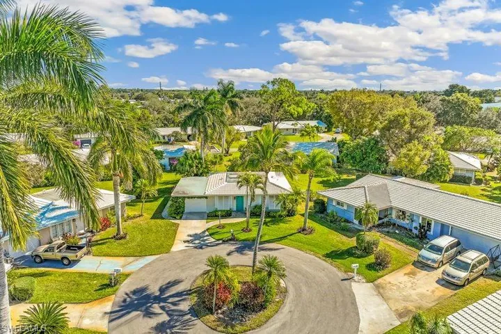 Aerial perspective of the front of the home and the neighborhood.