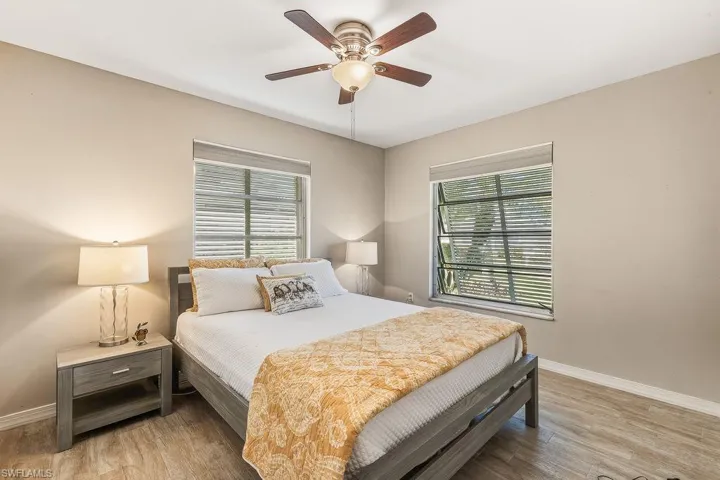Large Guest Bedroom featuring tiled wood-look flooring, ceiling fan, and a closet.