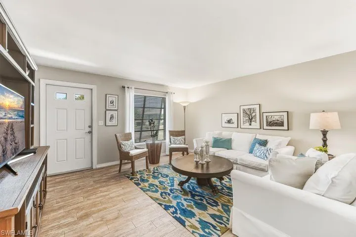 Living area featuring tiled floors and front entry into the home.