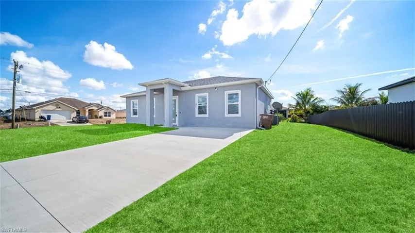View of front facade featuring concrete driveway and stucco siding