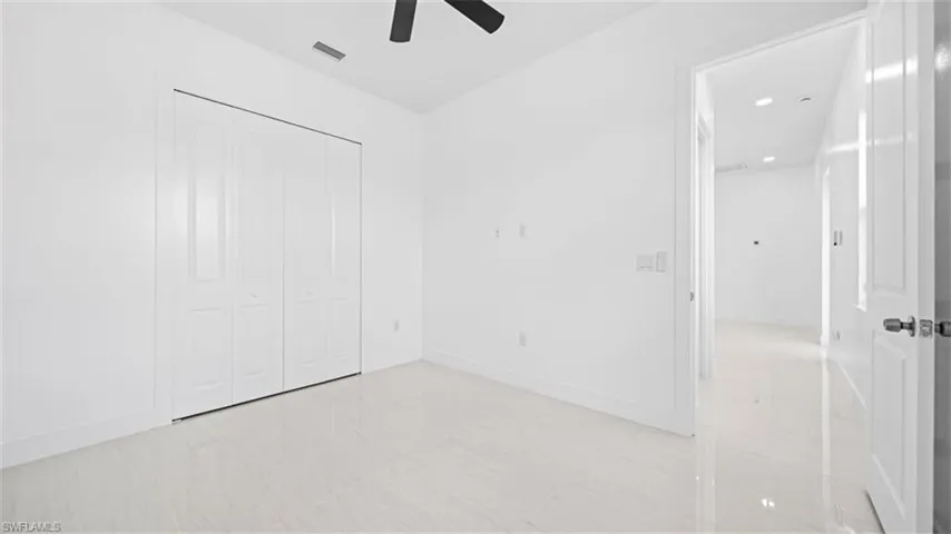 Unfurnished bedroom featuring a closet, ceiling fan, and recessed lighting