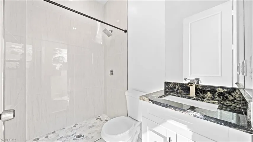 Full bathroom with vanity and a stall shower