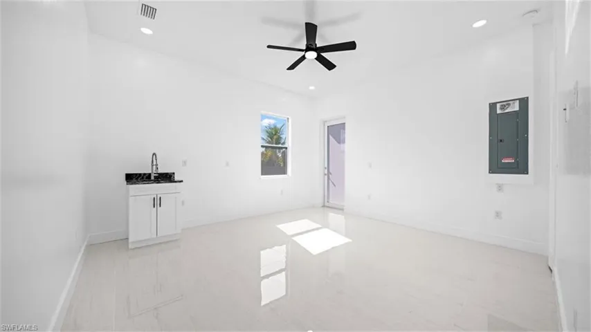 Empty room featuring electric panel, recessed lighting, and ceiling fan
