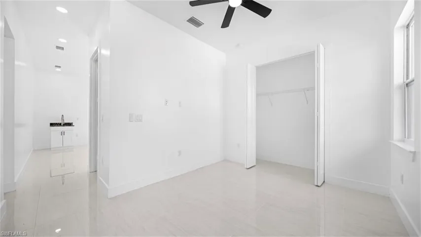 Unfurnished bedroom with ceiling fan, a closet, and recessed lighting