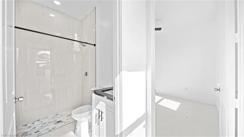 Full bath featuring a shower stall, vanity, and recessed lighting
