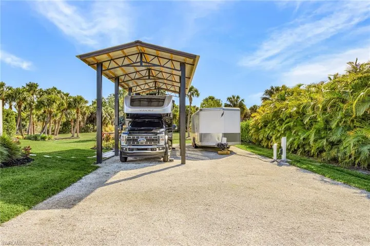 View of patio / terrace with a carport and driveway
