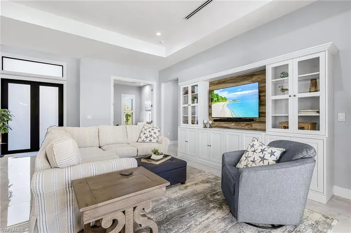 Living room featuring baseboards and recessed lighting