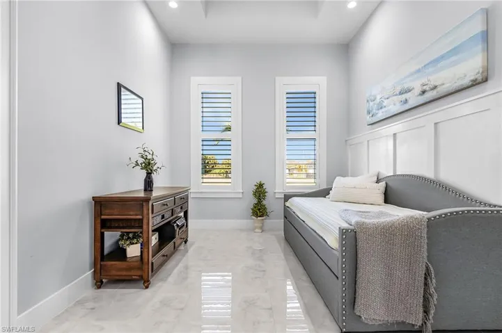 Bedroom with light marble finish floors and recessed lighting