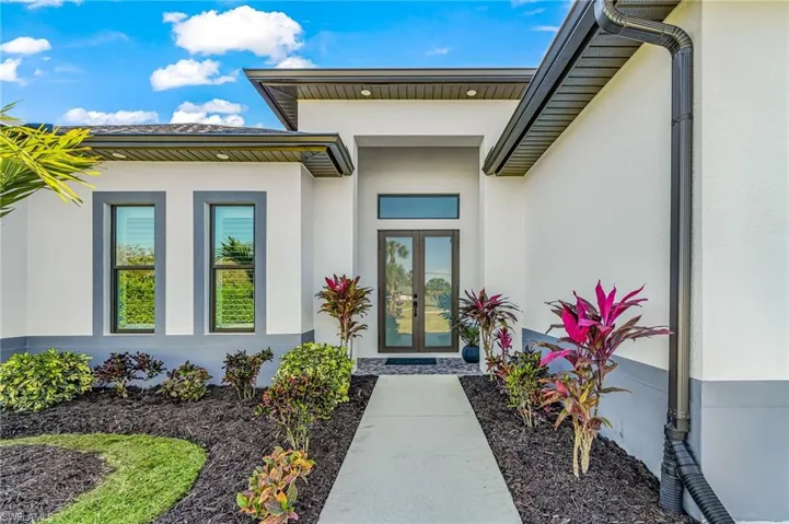 View of exterior entry featuring stucco siding