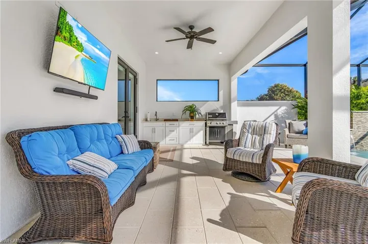 View of patio with a ceiling fan, an outdoor living space, a lanai, a sunroom, and area for grilling
