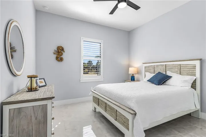 Bedroom featuring ceiling fan and baseboards