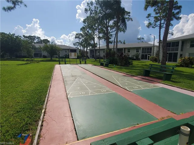 View of property's community with a lawn