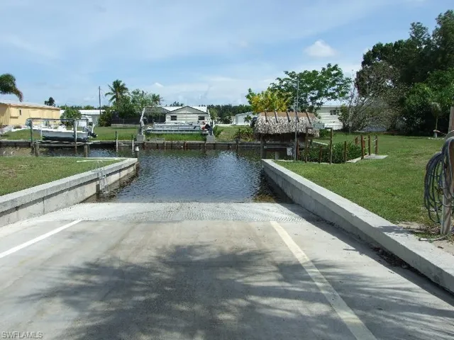 Dock area with a yard and a water view