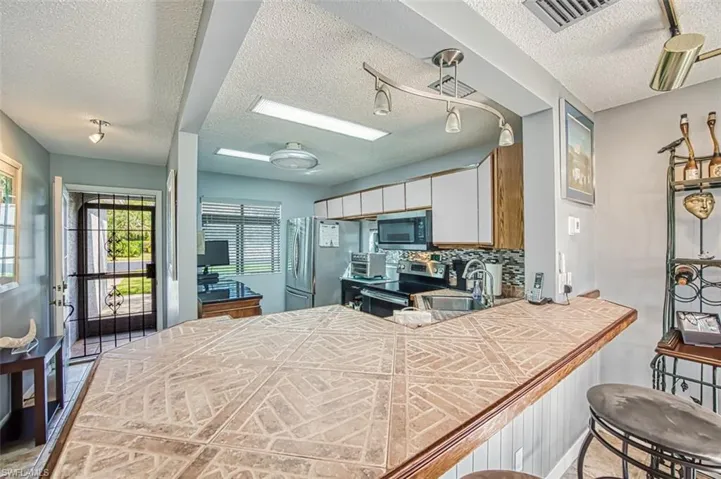 View from breakfast bar of kitchen & front door