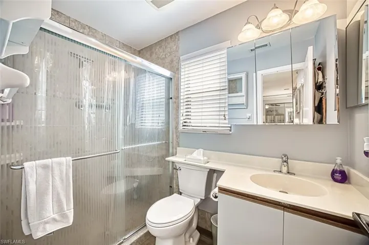 Primary bathroom with an enclosed shower.