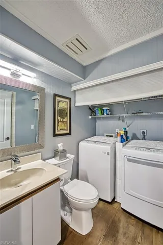 1st floor bathroom with shower and laundry room area.