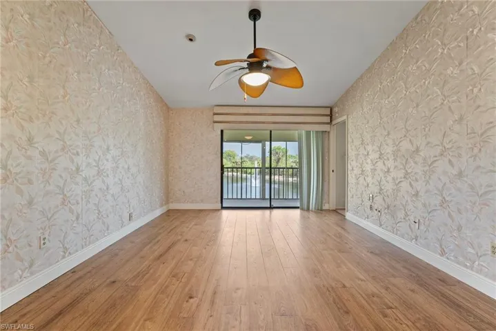 Unfurnished room with light hardwood / wood-style flooring and ceiling fan