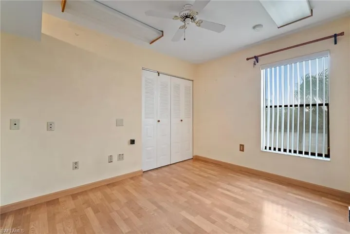 Unfurnished bedroom with light hardwood / wood-style flooring, ceiling fan, and a closet