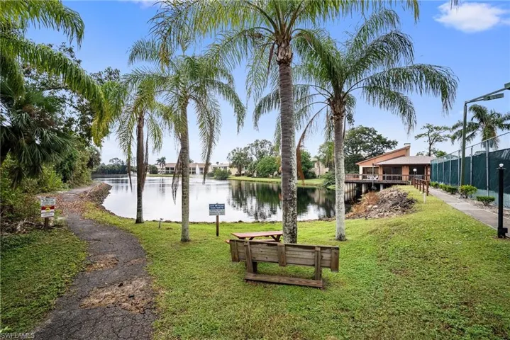 View of property's community featuring a water view and a yard