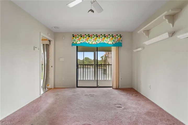 Unfurnished room featuring ceiling fan and carpet floors