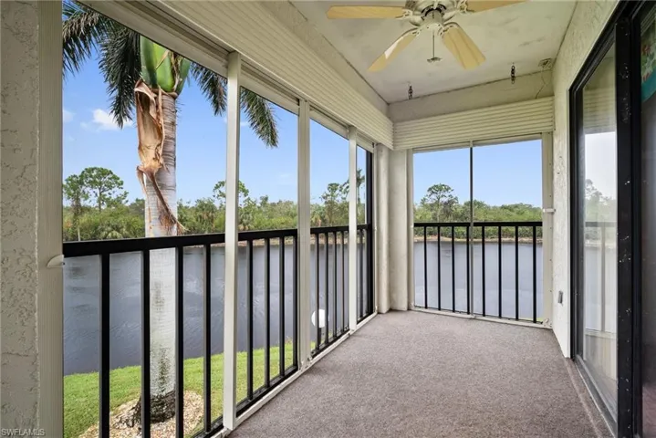 Unfurnished sunroom with ceiling fan