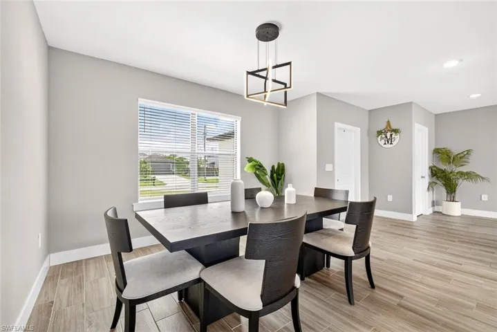 Dining room featuring wood tiled floors and baseboards
