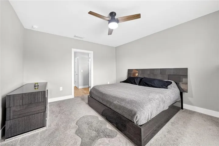 Bedroom featuring ceiling fan and light carpet