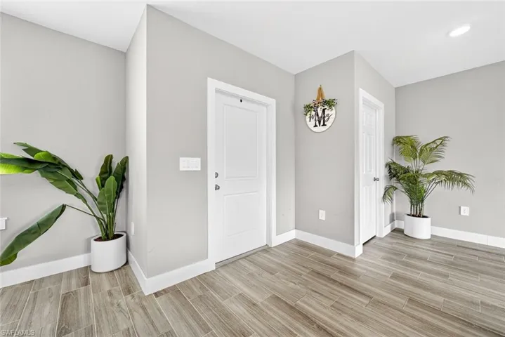 Entryway featuring baseboards and wood finish floors