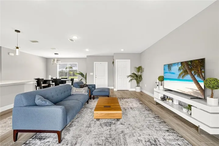 Living area featuring wood finish floors and recessed lighting