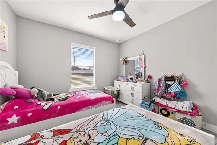 Bedroom with ceiling fan and carpet