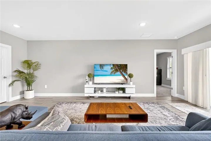 Living room with wood finished floors and recessed lighting
