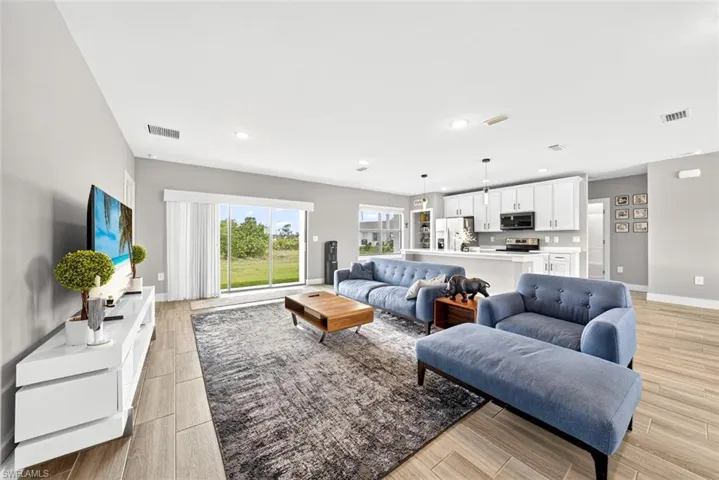Living room with wood finish floors and recessed lighting