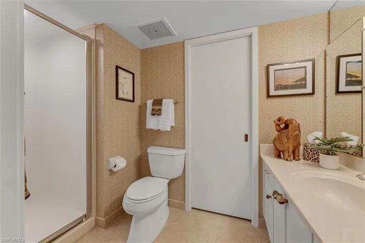 3rd Bath with an enclosed shower, tile flooring, vanity, and toilet