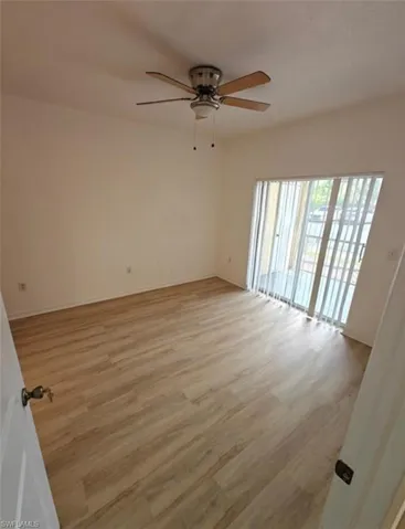 Empty room featuring light wood-style flooring and ceiling fan