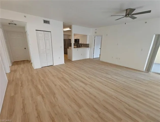 Unfurnished living room featuring light wood finished floors and ceiling fan