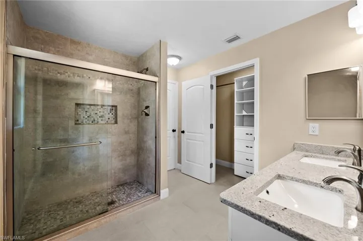 Updated Primary Bathroom with Dual Sinks & glass enclosed shower.