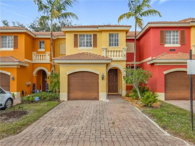 Mediterranean / spanish-style house with decorative driveway, stucco siding, a tiled roof, and an attached garage