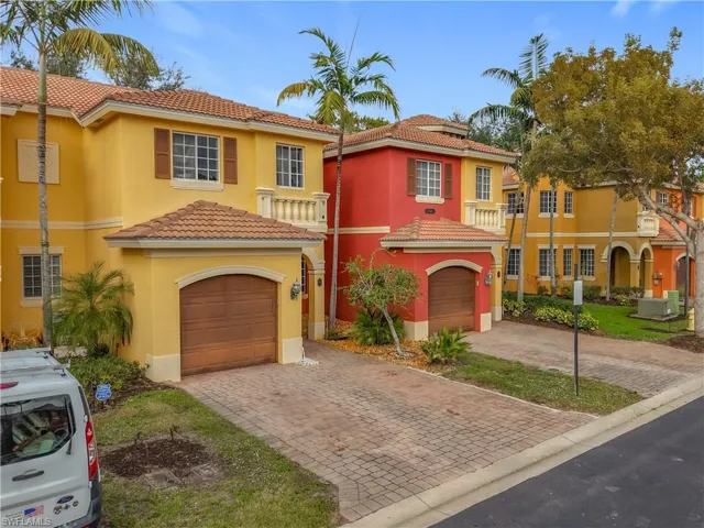 Mediterranean / spanish house with a tile roof, stucco siding, and driveway