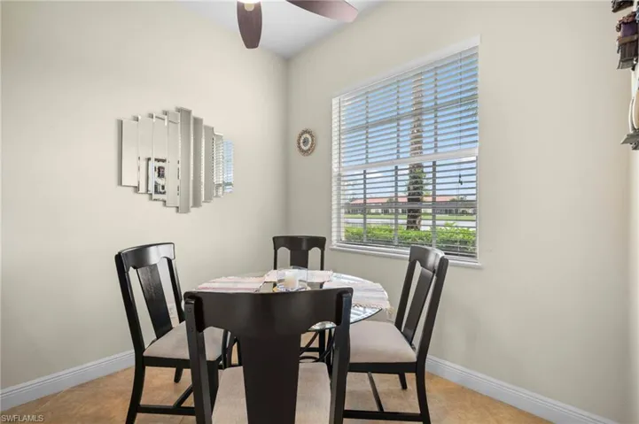 Tiled dining space featuring ceiling fan
