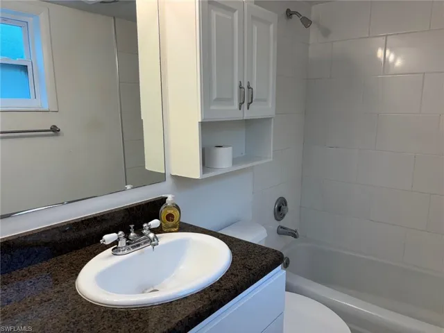 Full bathroom featuring vanity, toilet, and tiled shower / bath