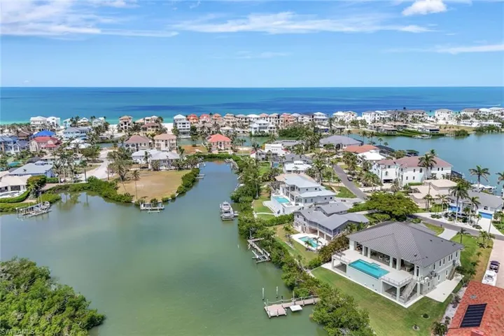 Aerial perspective of suburban area featuring a nearby body of water